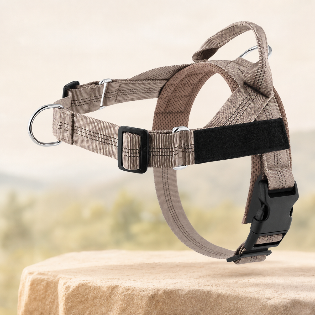 Adjustable reflective dog harness in beige on a warm stone setting