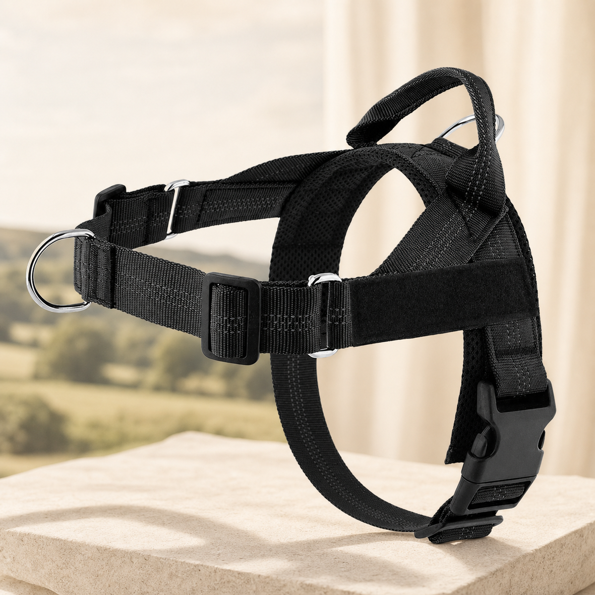 Adjustable reflective dog harness in black on a warm stone setting